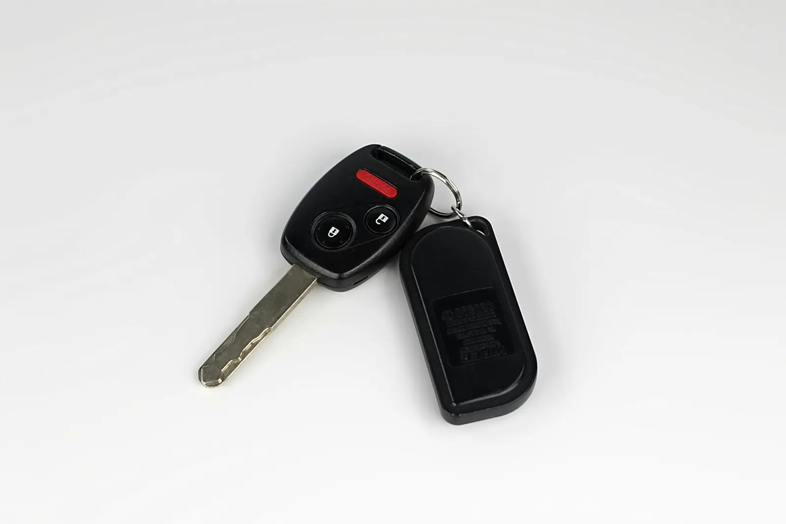 A rental car key and fob resting on a plain surface